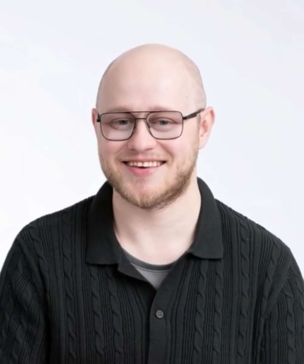 An open book. On the right spread, Dillon, a
young man with FA smiles.