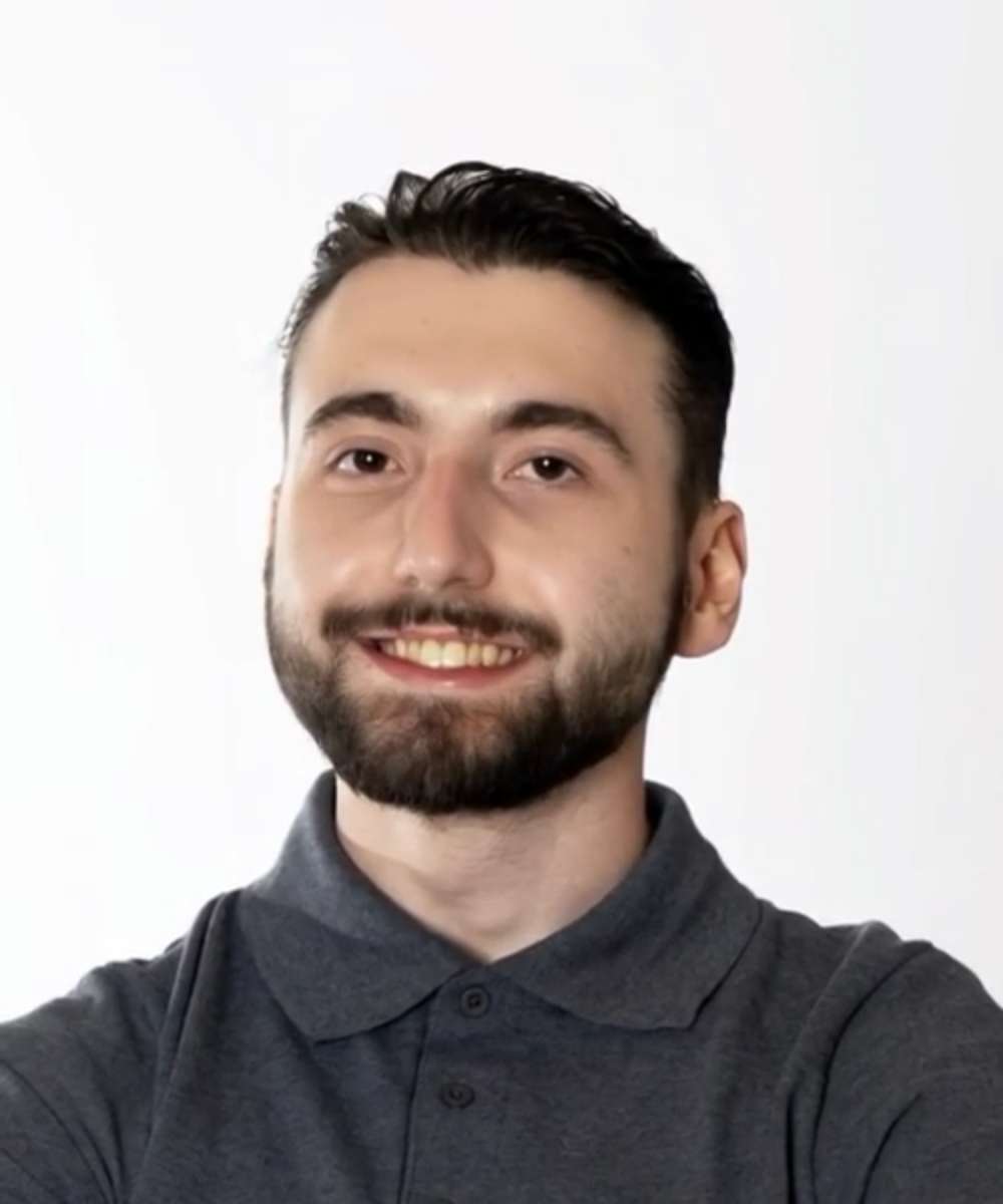 An open book. On the right spread, Tony, a young man with FA smiles.