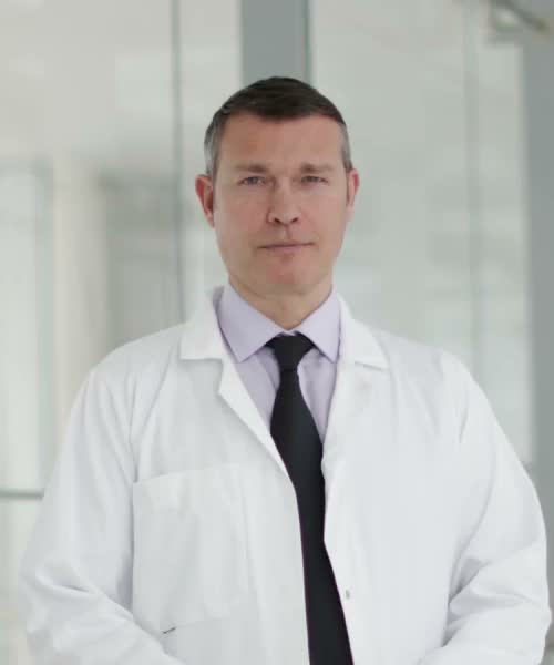 An open book. On the left spread, a male doctor looks ahead confidently